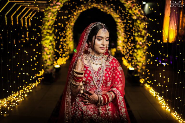 Bride standing for photoshoot in a vibrant and black bakground with a bookeh effect captured by wedding photographers in bhubaneswar