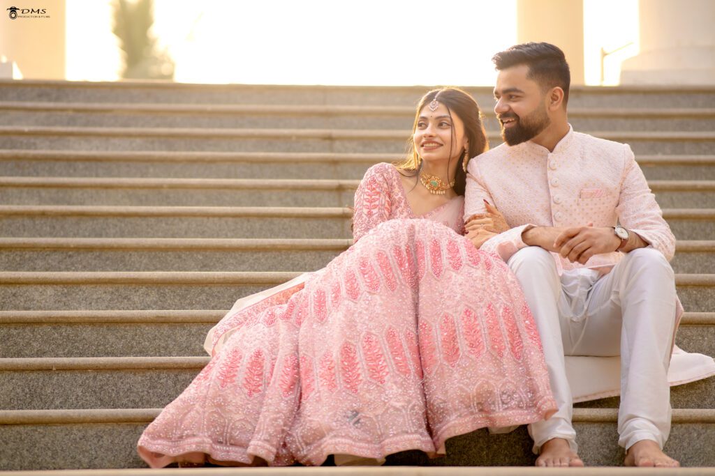 a pre wedding couple in bhubaneswar sitting together looking right side with a smile on their face