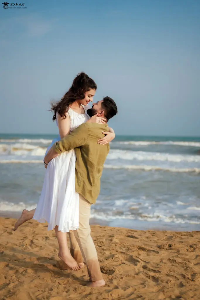 Pre wedding Photography of couple in Puri sea beach where boy lifts girl in his lap