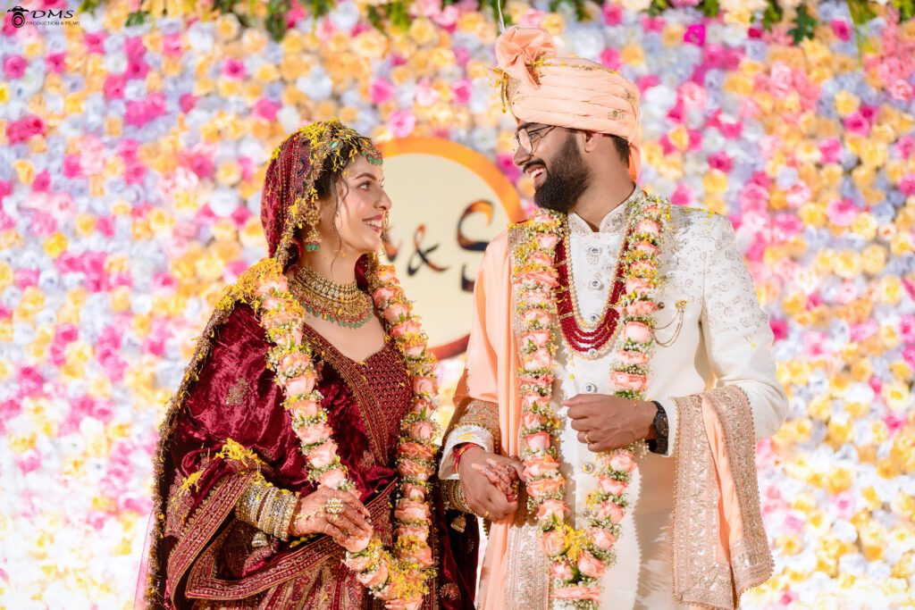 Wedding photograph of Bride and Groom on varmala stage looking at each ohter