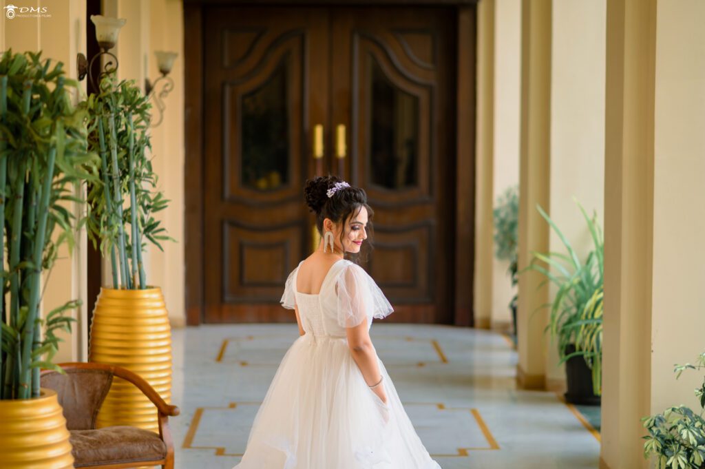 A beautiful wedding bride in a white gown standing backward